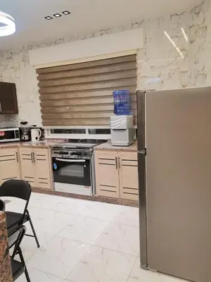 a kitchen with a stainless steel refrigerator in it at دار عدنان للشقق الفندقية المفروشة in Al Mafraq