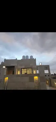 a large building with lights in front of it at 3BR Furnished Apartment for Rent - PART OF VILLA in Amman