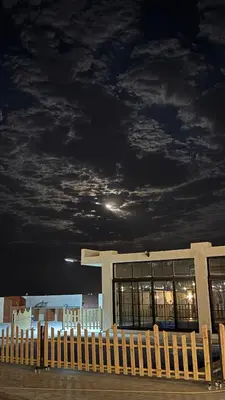 a building with a cloudy sky at night at olive tree farm and chalet - مزرعه و شاليه شجره الزيتون