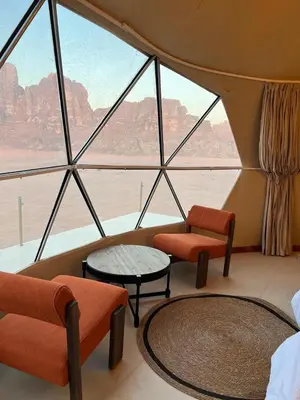 a room with a large window with chairs and tables at Dania Luxury Camp in Wadi Rum