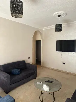 a living room with a couch and a table at الجبيهة 2 نوم aljubiha apartment in Amman