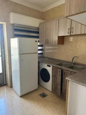 a kitchen with a white refrigerator and a dishwasher at الجبيهة 2 نوم aljubiha apartment in Amman