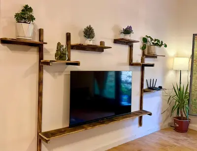 a living room with a flat screen tv on a wall at Spacious central apartment in Amman