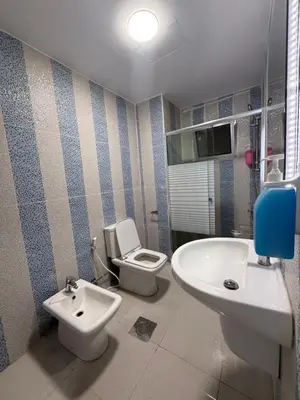a bathroom with a toilet and a sink at 3bedroom aprt of 200sqm near movenpick hotel amman in Amman