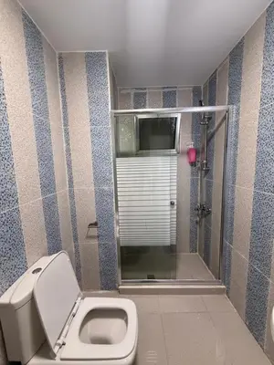 a bathroom with a toilet and a shower at 3bedroom aprt of 200sqm near movenpick hotel amman in Amman
