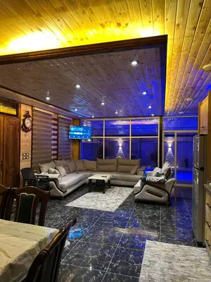 a large living room with couches and a table at شاليه وكوخ البركه Albarakah chalets in Ajloun