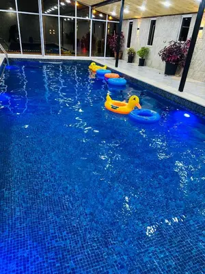 a swimming pool with some inflatable toys in the water at شاليه وكوخ البركه Albarakah chalets in Ajloun