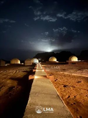 a long road in the desert at night at LMA Rum Luxury Camp in Wadi Rum