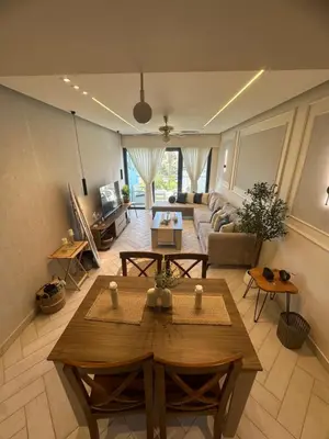 a living room with a table and a couch at شقه شاطئيه in Aqaba
