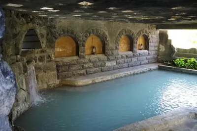 a pool of water in a building with arches at Sossita Guesthouse & Boutique Resort
