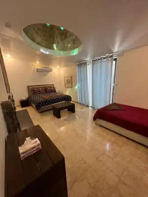 a living room with a bed and a couch at Sossita Guesthouse & Boutique Resort