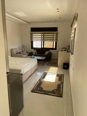 a bedroom with a bed and a living room at For Rent ,New Furnished Rooftop in Shafa Badran in Amman