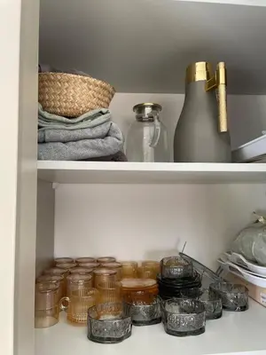 a pantry with jars and a vase on a shelf at For Rent ,New Furnished Rooftop in Shafa Badran in Amman