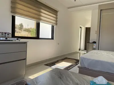 a bedroom with a bed and a window at For Rent ,New Furnished Rooftop in Shafa Badran in Amman