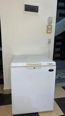 a white refrigerator freezer sitting next to a wall at Jordan house in Al Bāriḩah