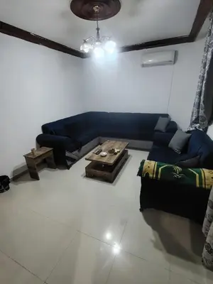 a living room with a couch and a table at الشهم 10 in Irbid