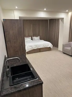 a bedroom with a bed and a sink with a sink at Midtown Lweibdeh Hostel in Amman