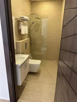 a bathroom with a sink and a toilet and a shower at Midtown Lweibdeh Hostel in Amman