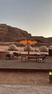 a group of benches and tables in the desert at Lamis Camp Wadi Rum in Aqaba