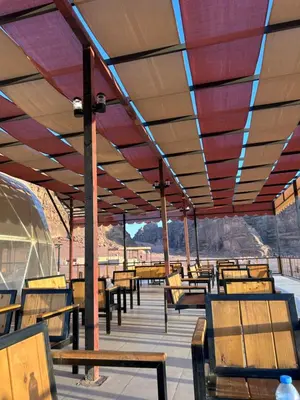 a group of benches sitting under a roof at Lamis Camp Wadi Rum in Aqaba