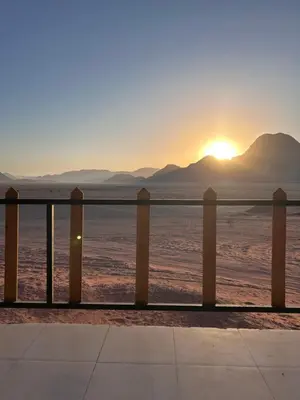 a view of the sun setting over the desert at Lamis Camp Wadi Rum in Aqaba