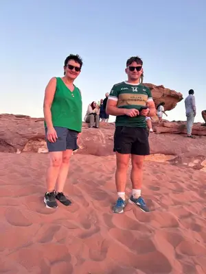 two men standing in the sand in the desert at Lamis Camp Wadi Rum in Aqaba