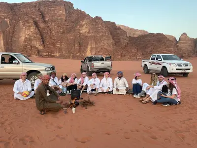 a group of people posing for a picture in the desert at Dune Camp Tours in Wadi Rum