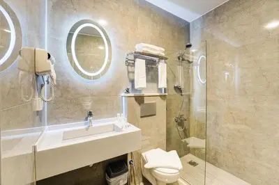 a bathroom with a sink and a toilet and a shower at aqaba hills hotel in Aqaba