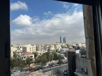 a view of a city from a window at One bedroom apartment in the heart of west Amman in Amman