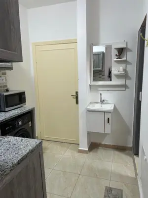 a kitchen with a white door and a sink at One bedroom apartment in the heart of west Amman in Amman