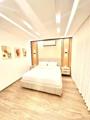 a bedroom with a large bed in a room at Brand New Stylish Luxe Apartment Near US Embassy Abdoun in Amman