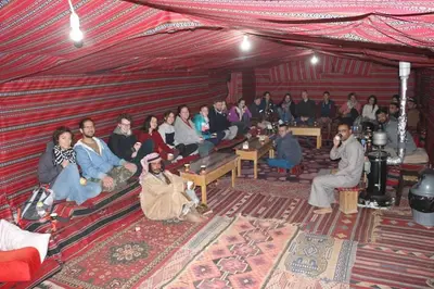a group of people sitting in a tent at Martian Desert Camp in Wadi Rum