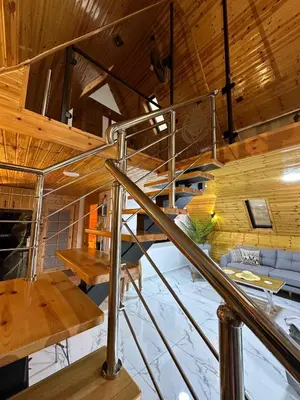 a spiral staircase in a room with wooden ceilings at أكواخ المها oryx cottage in Ajloun