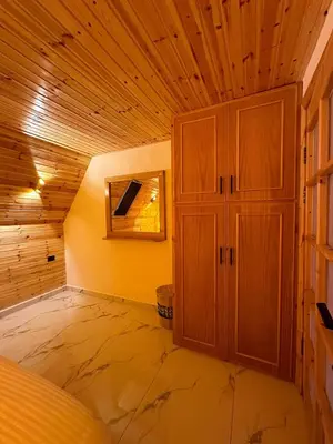 a room with a wooden ceiling and a cabinet at أكواخ المها oryx cottage in Ajloun