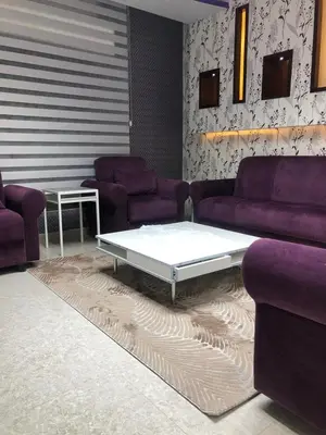 a living room with purple couches and a coffee table at تقاطع الحرمين -خلف برجر كينج دوار الكيلو in Amman
