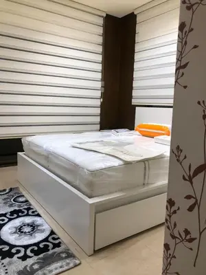 a white bed in a room with a window at تقاطع الحرمين -خلف برجر كينج دوار الكيلو in Amman