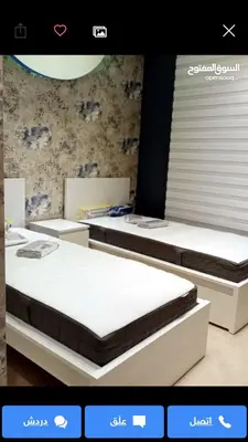 two beds in a room with at تقاطع الحرمين -خلف برجر كينج دوار الكيلو in Amman