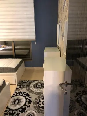 a white refrigerator in a room with a rug at تقاطع الحرمين -خلف برجر كينج دوار الكيلو in Amman