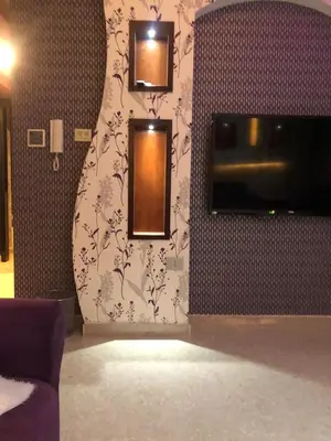 a room with a wall with two mirrors and a tv at تقاطع الحرمين -خلف برجر كينج دوار الكيلو in Amman