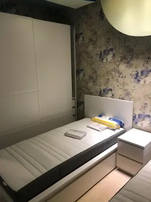 a bedroom with a bed with a cabinet and two towels at تقاطع الحرمين -خلف برجر كينج دوار الكيلو in Amman