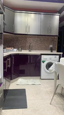a kitchen with a washing machine and a sink at تقاطع الحرمين -خلف برجر كينج دوار الكيلو in Amman