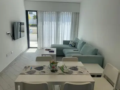 a living room with a couch and a table and chairs at العقبة in Aqaba