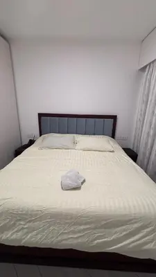 a large white bed with a white towel on it at One bedroom at ayla azure in Aqaba