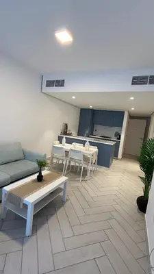 a living room with a couch and a table at One bedroom at ayla azure in Aqaba