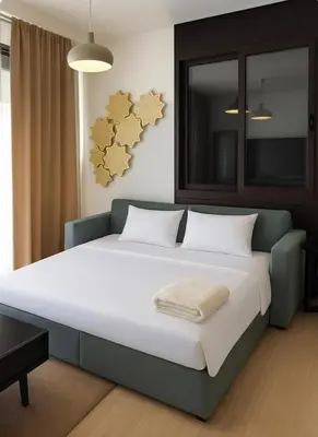 a bedroom with a large bed in a room at Ayla Oasis Golf Apartment - Ayla Vista in Aqaba