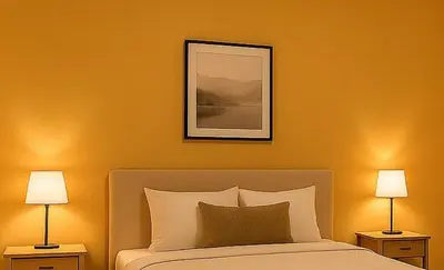 a bedroom with a bed with two lamps and a picture at Stay with Obada Private Room in Amman