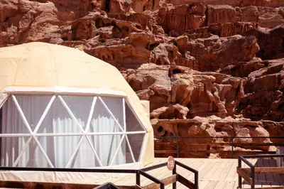 a dome tent in front of a rocky mountain at Luxury Spiral Camp in Maḩaţţat Dīsah
