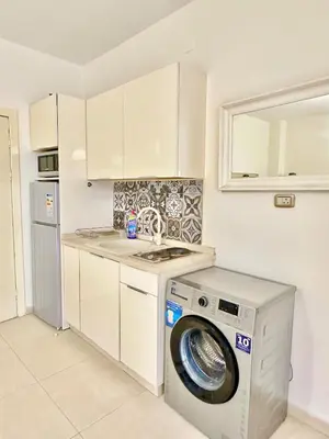 a kitchen with a washing machine and a washer at Abdoun Modern 2BR Apartment Near US Embassy in Amman