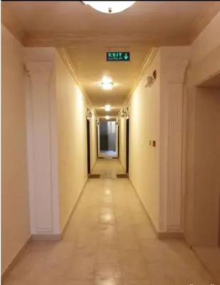 an empty hallway in a building with a sign on the ceiling at Abdoun Modern 2BR Apartment Near US Embassy in Amman