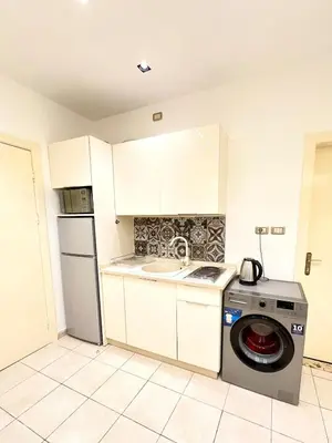 a kitchen with a washing machine and a sink at Abdoun Modern Apartment Near US Embassy in Amman